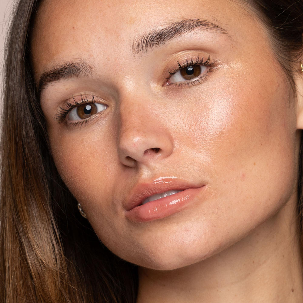 Close-up of Jouer Powder Highlighter Rose Quartz being applied for luminosity.
