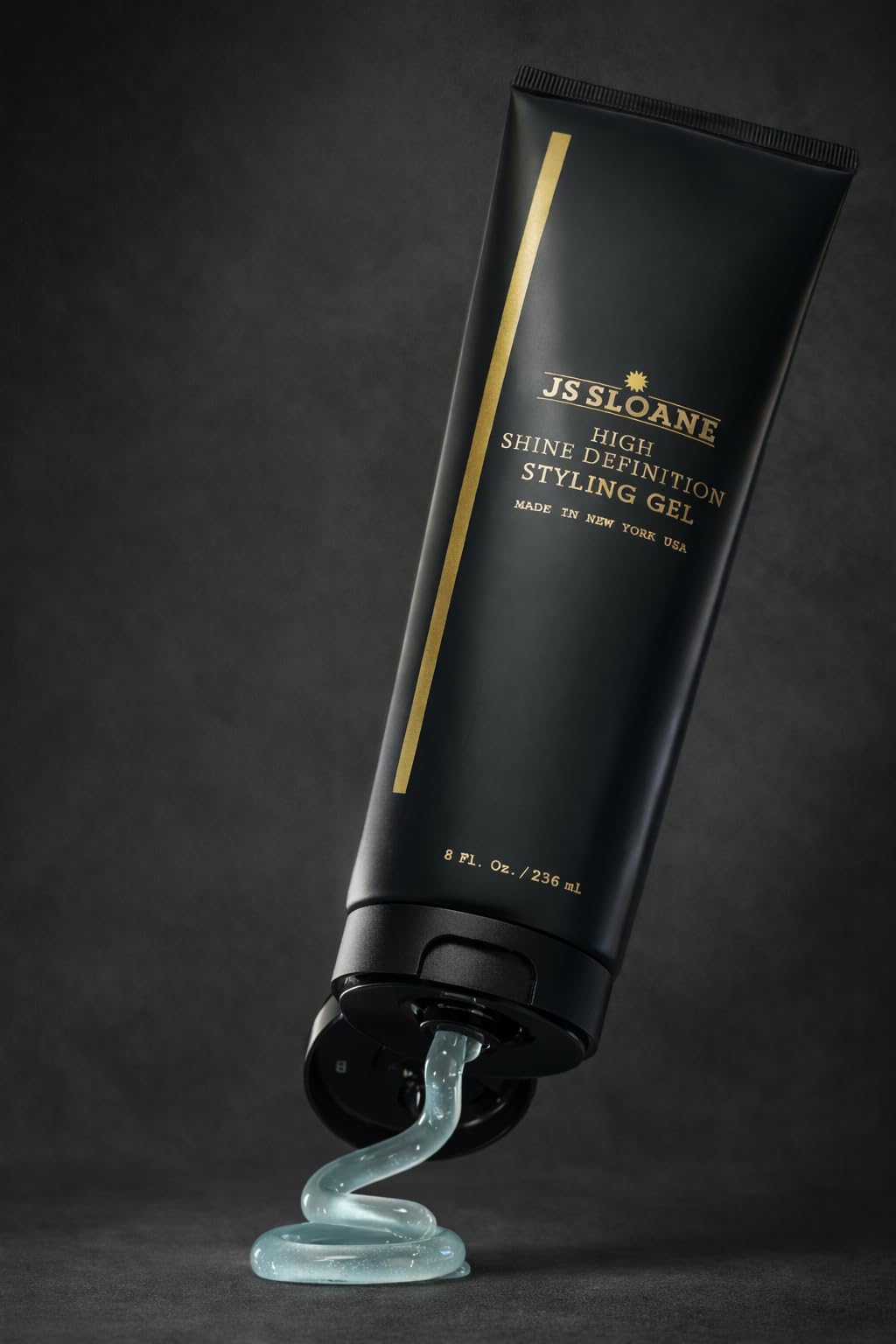 JS Sloane styling gel application hand for smooth, flop-free slick-back looks.