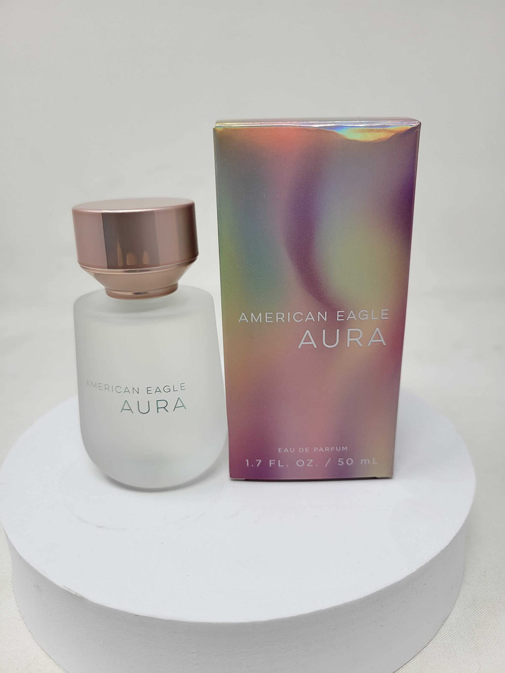 Aura EDT spray application depicting easy application for daytime use.