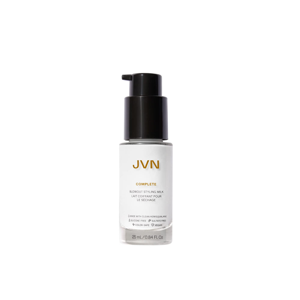 JVN Complete Blowout Styling Milk bottle pour showing easy application and heat protection preparation.