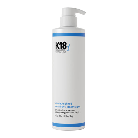 K18 Damage Shield Shampoo bottle front view highlighting frizz control and detangling.