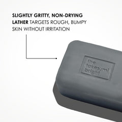 Kaia Naturals Takesumi Bright ingrown bar held in hand showing portable 2.4oz size.