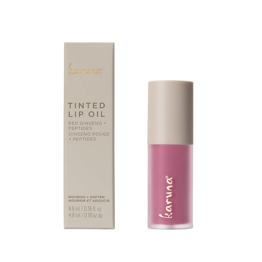 Lip oil applicator applying Karuna Dream for a smooth, conditioning tint.
