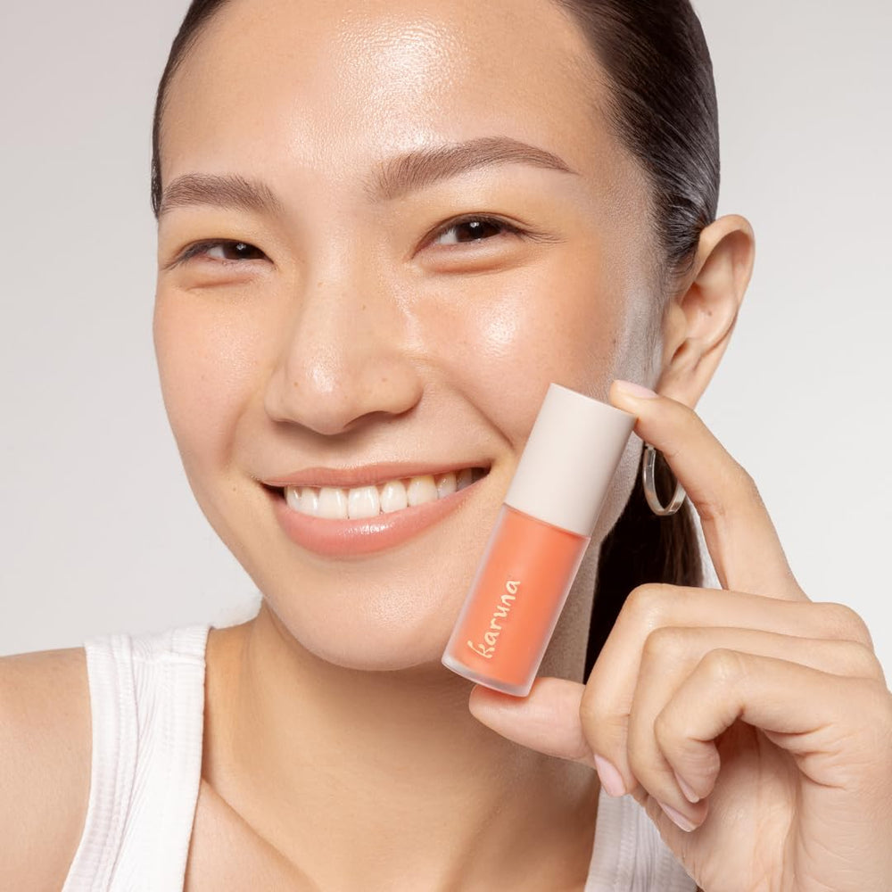 Karuna Lip Oil Pause application swatch shows color with hydration.