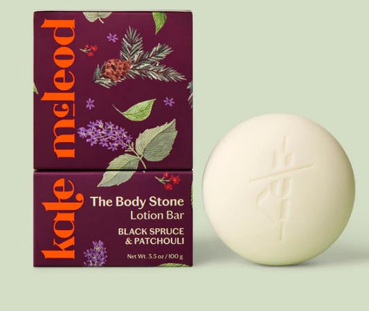 Kate McLeod Black Spruce & Patchouli Lotion Bar in use, delivering deep hydration with a velvety finish.