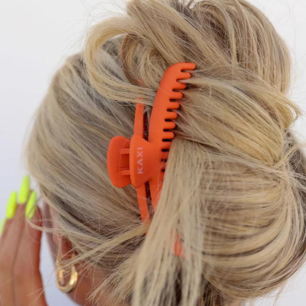 KAXI midi claw worn in hair during activity.