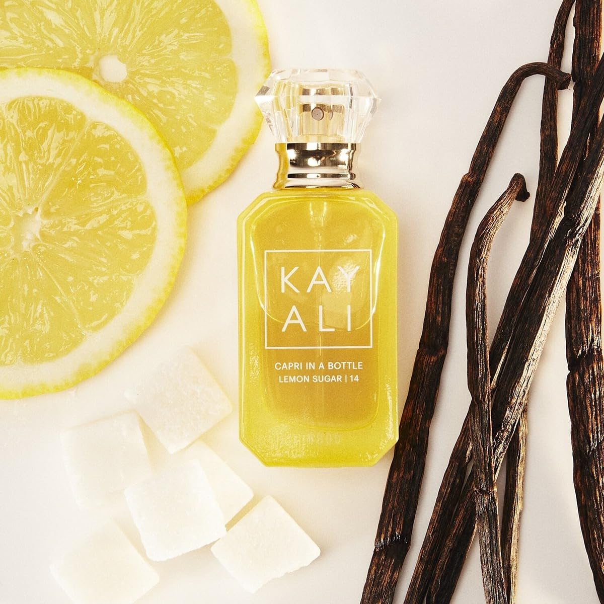 KAYALI Capri in a Bottle Lemon Sugar freesia-raspberry accent adds a lively twist.