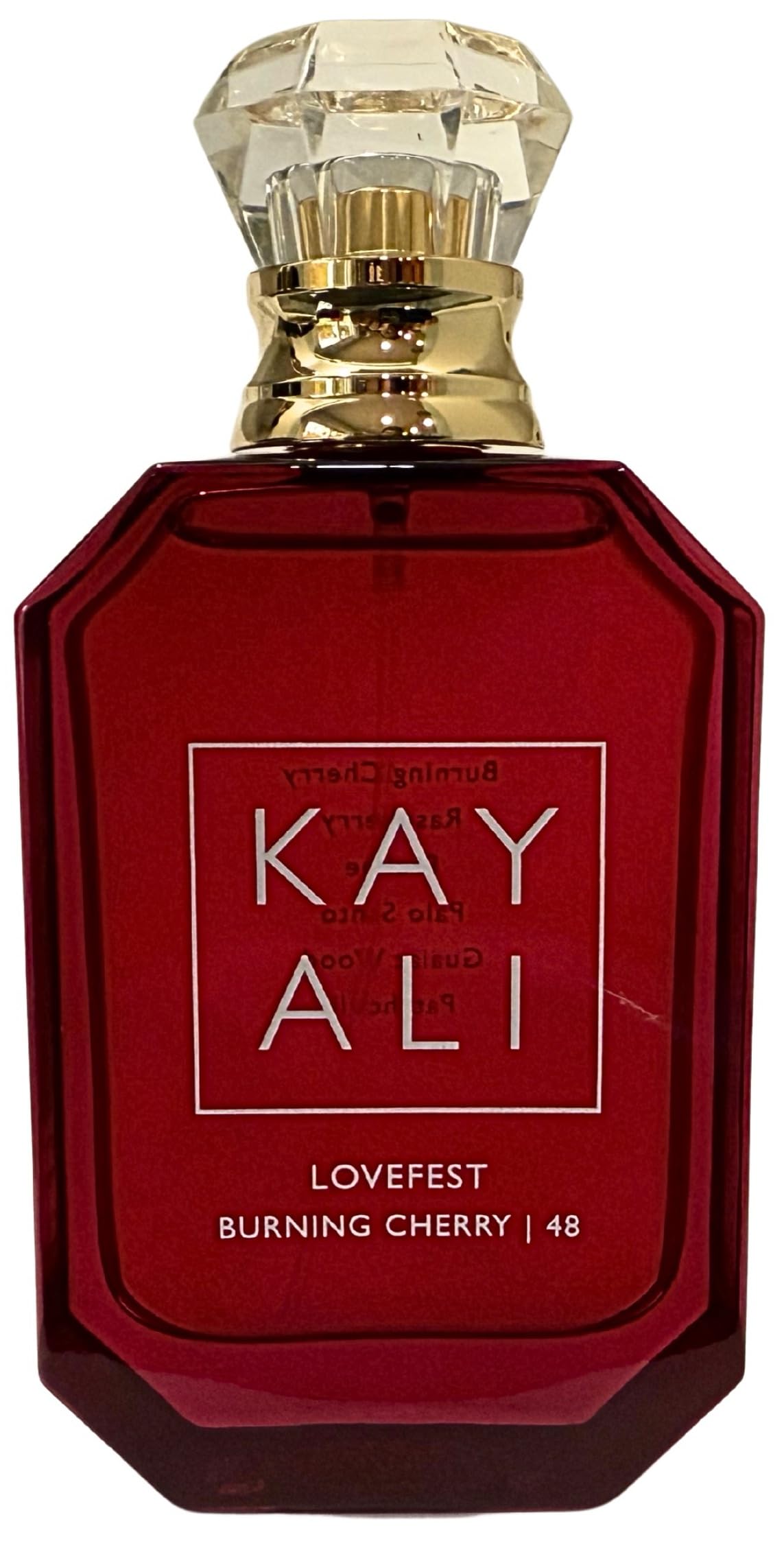 KAYALI Lovefest Burning Cherry bottle close-up showing rich ruby tones for evening glamour
