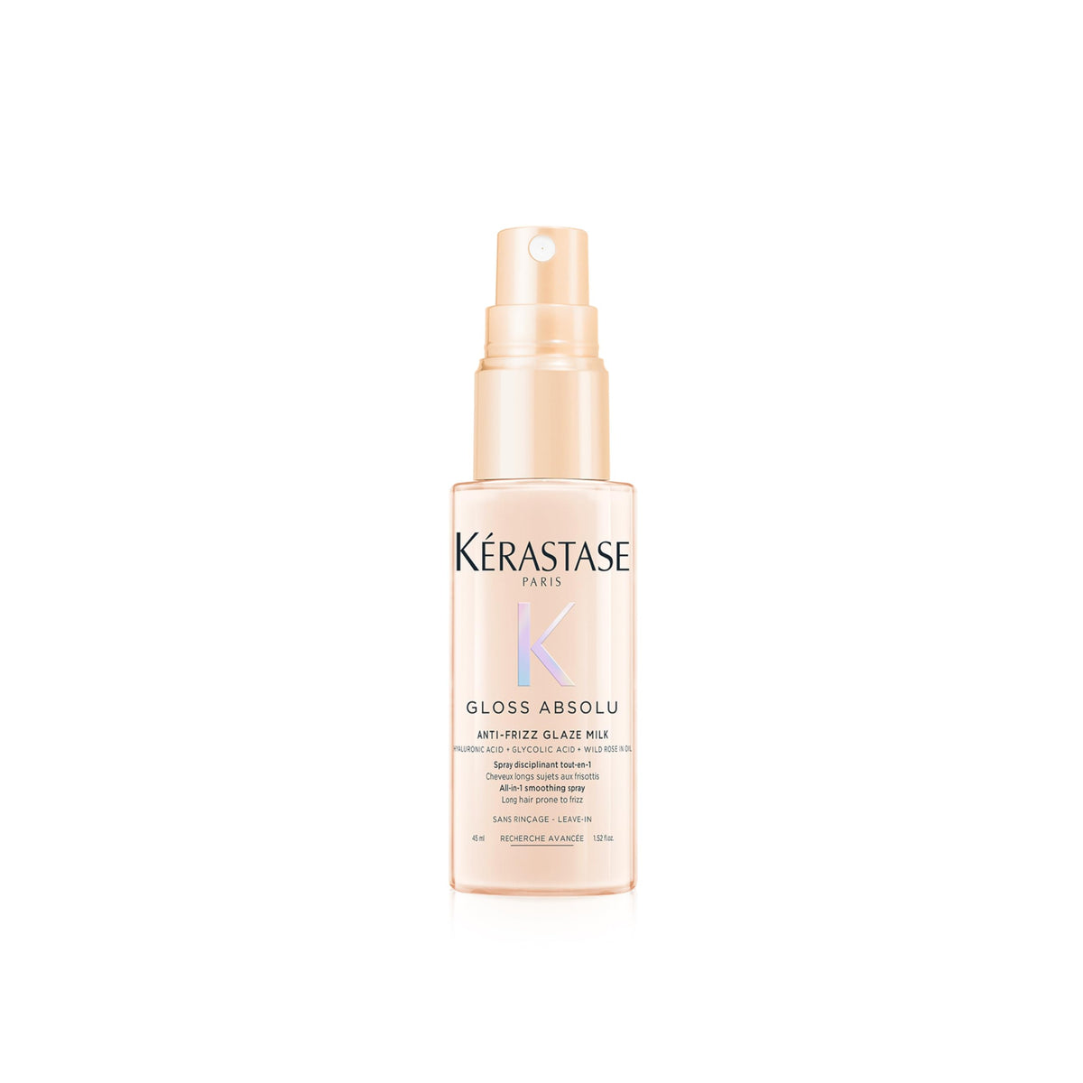 Kerastase Gloss Absolu Glaze Milk bottle on desk, highlighting detangling and smoothness for long hair.
