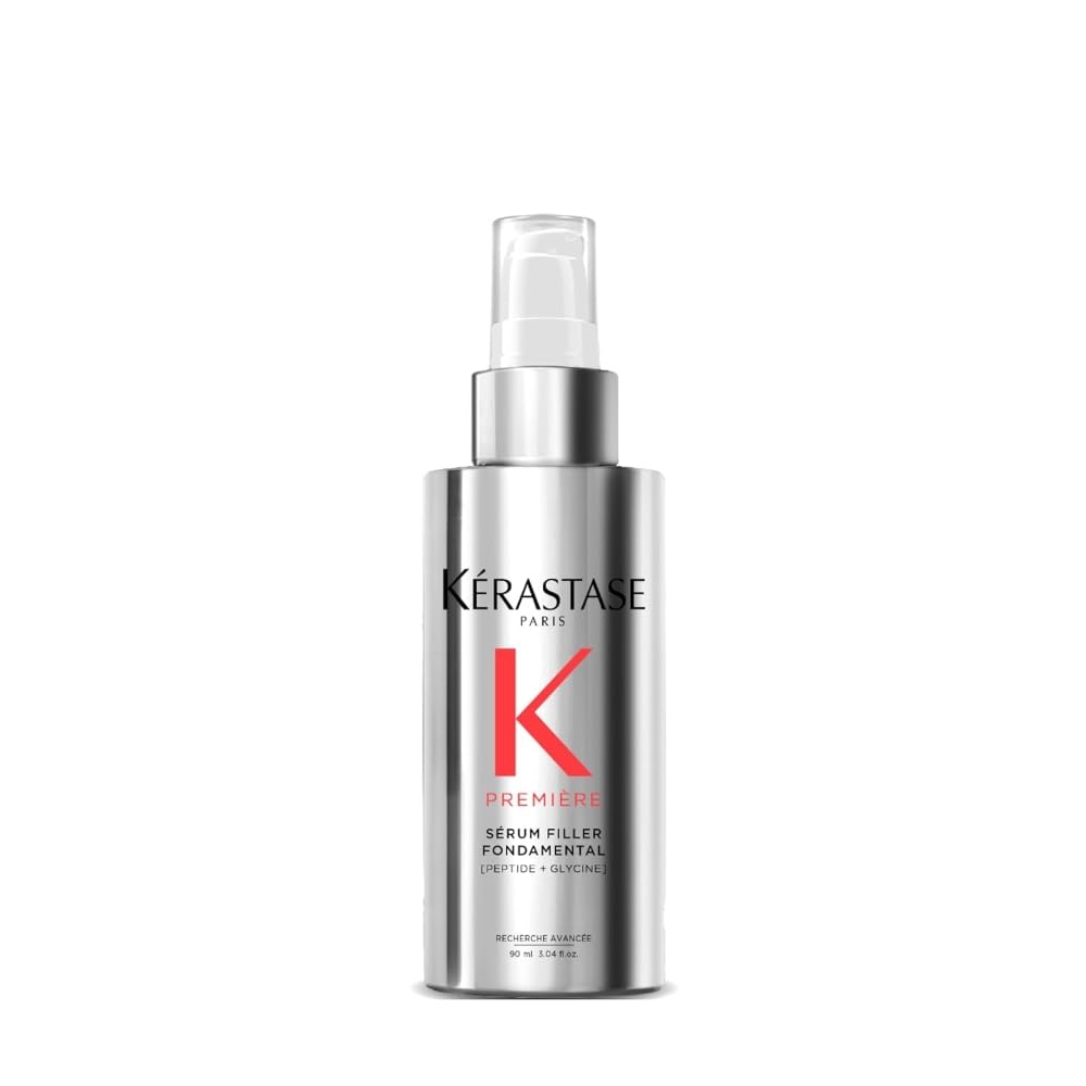 Kerastase Premiere serum bottle pouring for smooth hair and frizz control.