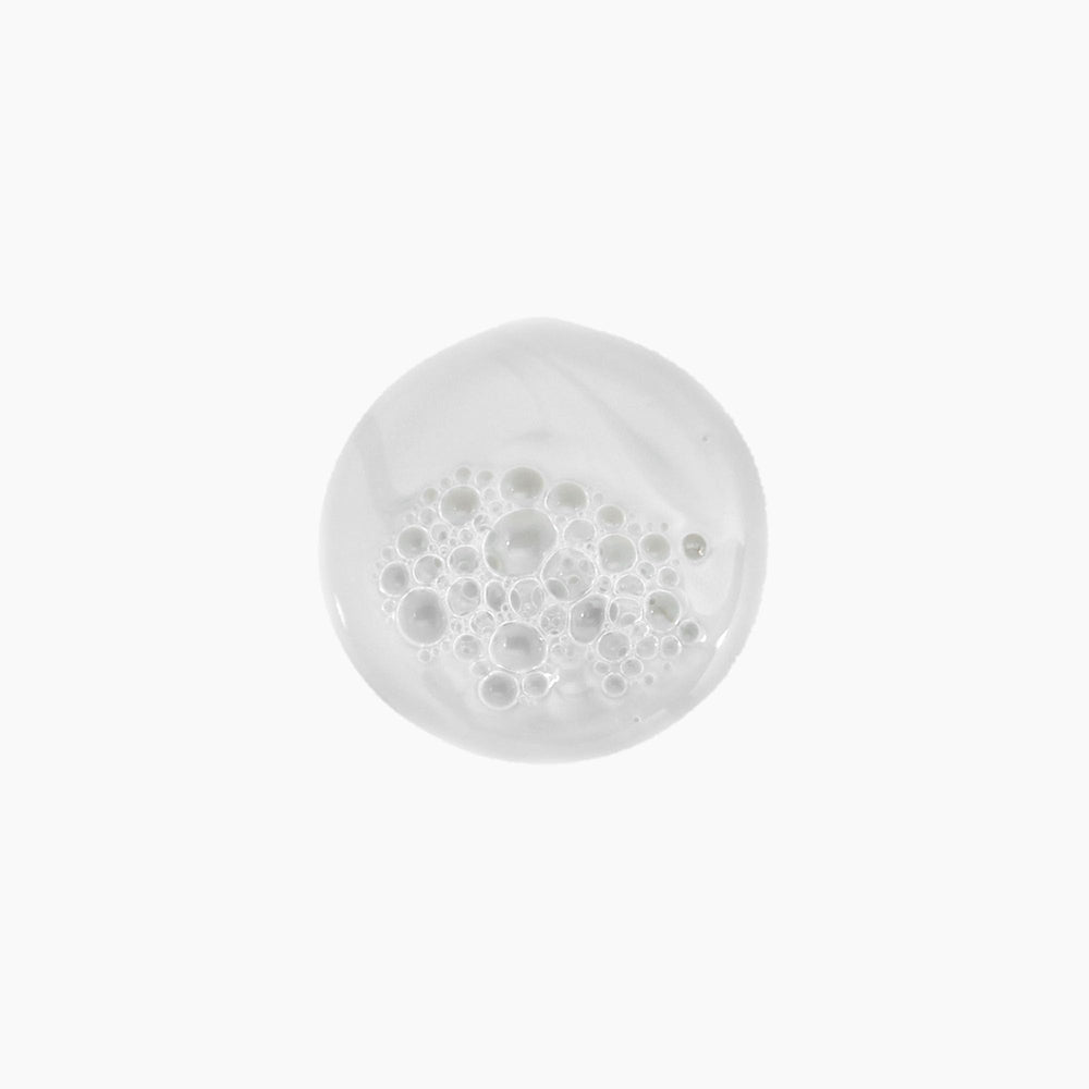 Kevin Murphy Young Again Wash pour shows easy dispensing for clean, soft strands.