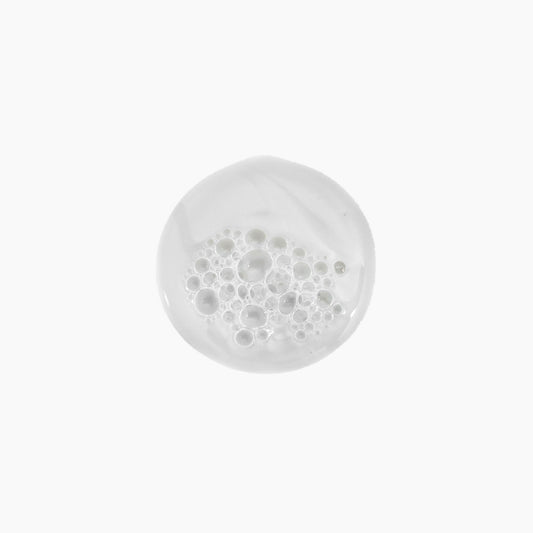 Kevin Murphy Young Again Wash pour shows easy dispensing for clean, soft strands.