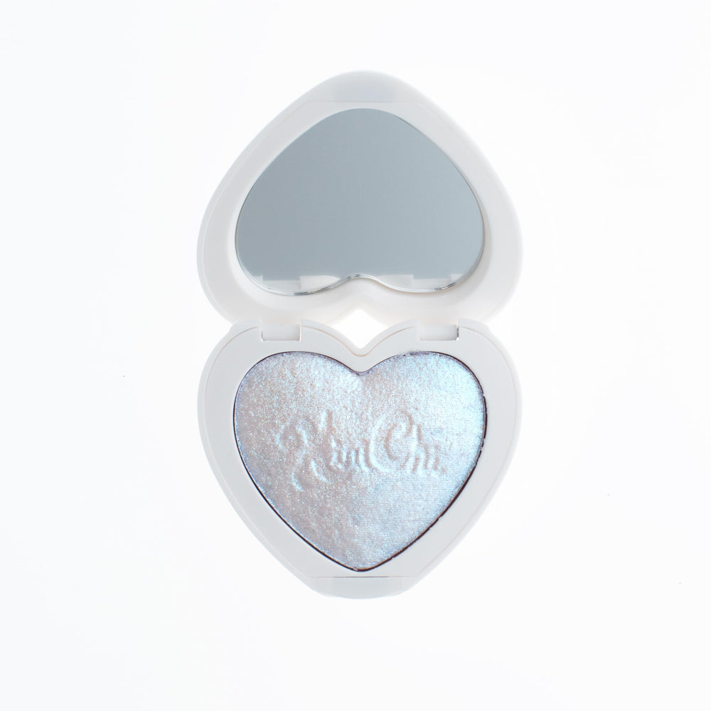 Kimchi Chic Mini Pearl Gone Wild highlighter compact with pearlescent glow on cheeks.