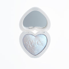 Kimchi Chic Mini Pearl Gone Wild highlighter compact with pearlescent glow on cheeks.