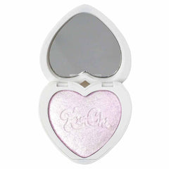 KimChiChic Pearl Gone Wild highlighter on the face for a pearlescent glow.