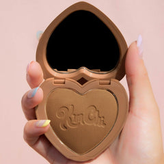 KimChiChic bronzer compact open with mirror for precise, on-site glow touch-ups.