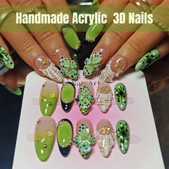 KimKista Floral Oasis almond nails in green ombre with floral accents for elegance.