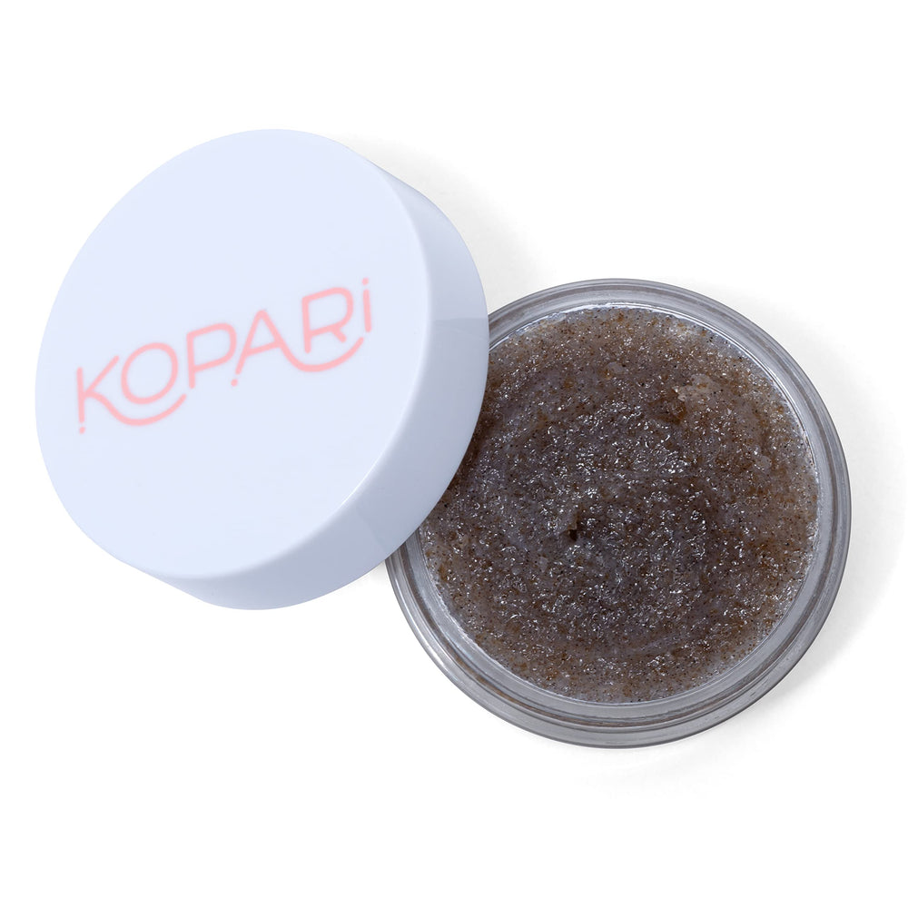 Kopari Coconut Lip Scrubby brown sugar particles buffing dry lips softly.