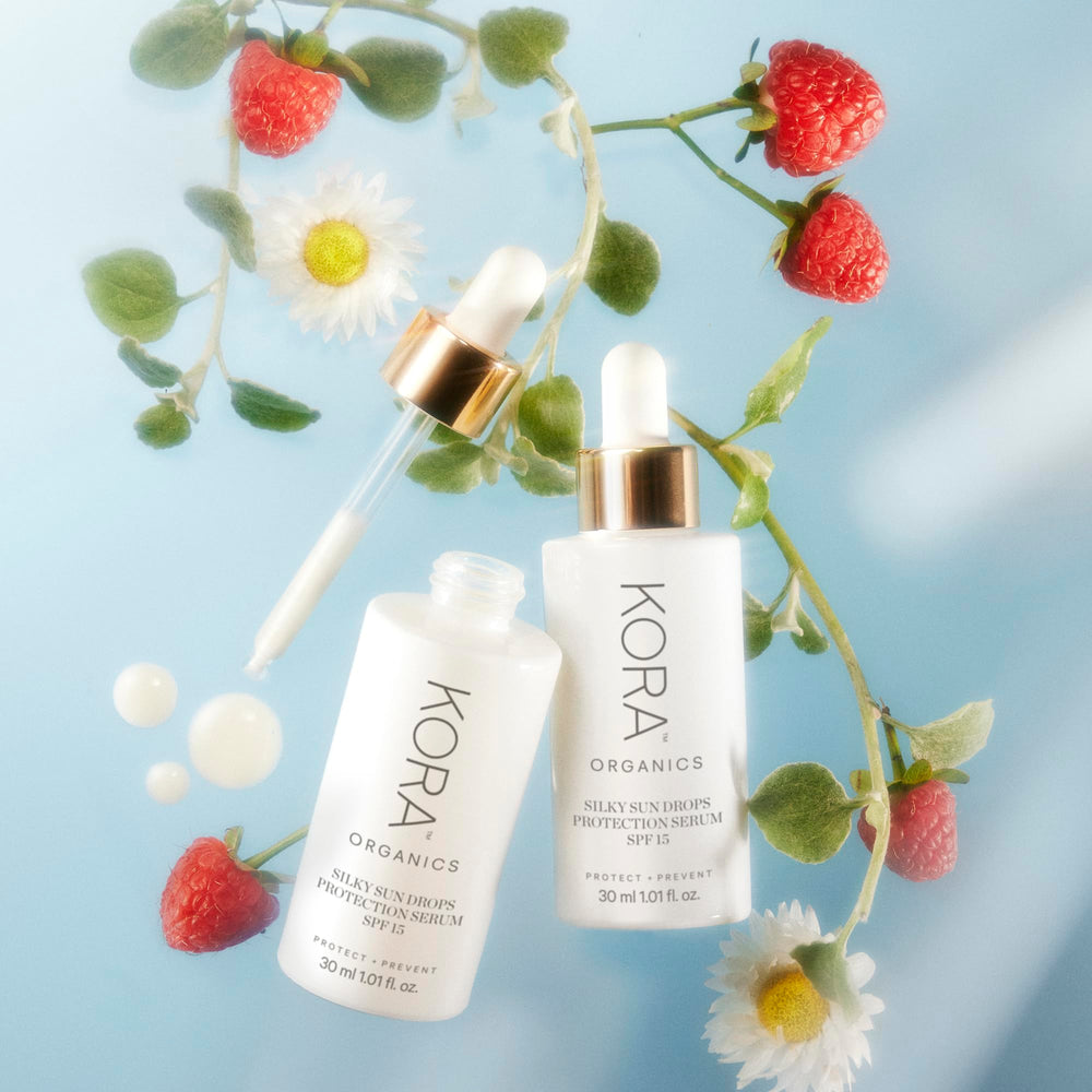 KORA Organics Silky Sun Drops packaging notes blue light protection benefits.