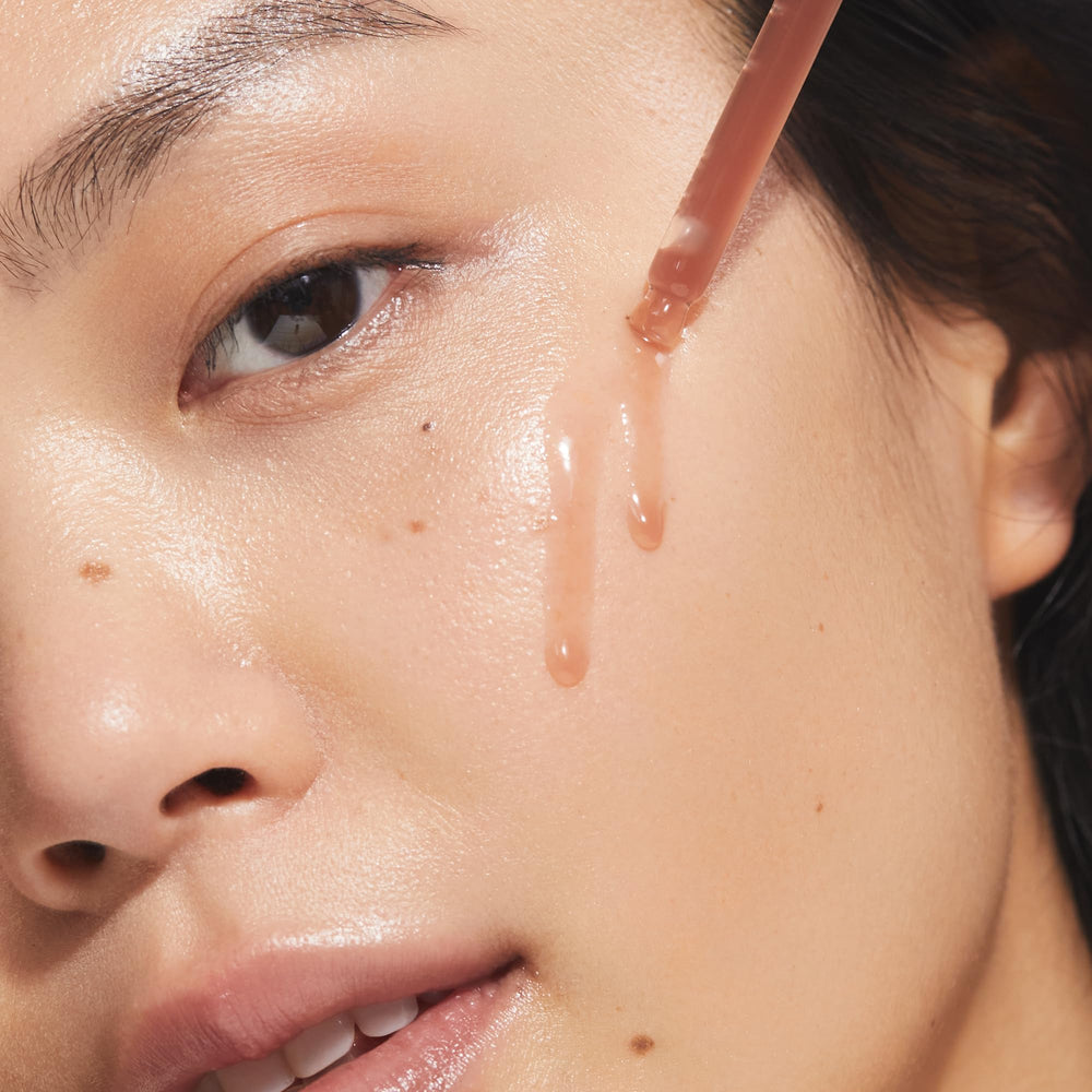 KORA Organics Turmeric Glow Drops on skin shows smooth texture and dewy finish.