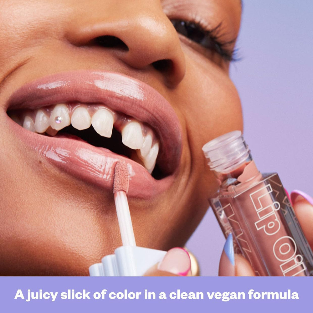 Kosas Wet Lip Oil Gloss layered over lipstick for lasting brightness.