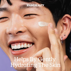Applying KraveBeauty Great Barrier Relief Serum on the face with gentle massage.