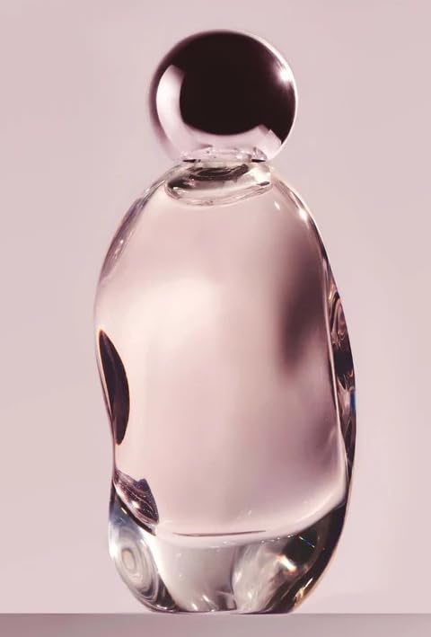 KYLIE Cosmic perfume bottle close-up showing amber glow for evening wear.