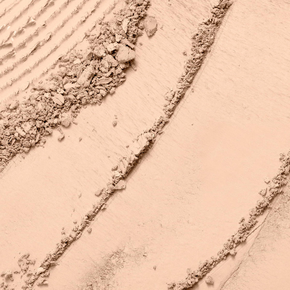 Lancôme Dual Finish powder texture close-up reveals silky natural matte finish.