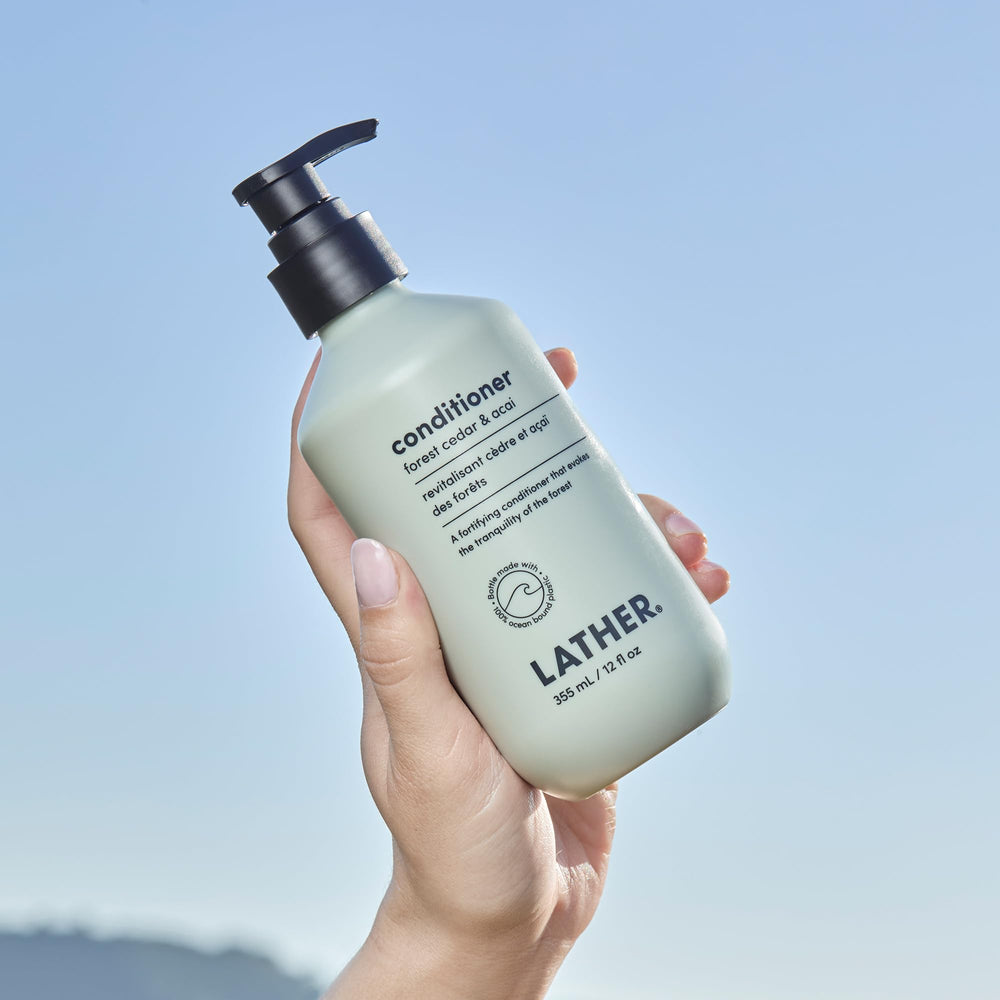 Applying LATHER Forest Cedar & Acai Conditioner nourishes and detangles hair