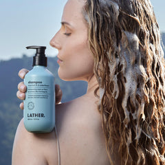 LATHER Mountain Fir and Elderflower shampoo being poured, refreshing natural aroma.