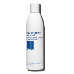 LATHER Yuzu Bergamot Hair Wash bottle pours for a refreshing cleanse.