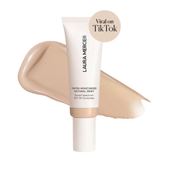 Texture swirl demonstrates sheer to light coverage on Laura Mercier tinted moisturizer.