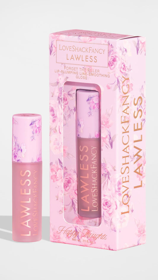 Close-up swatch of Lawless gloss in Happy Thoughts pink for day-to-night wear.