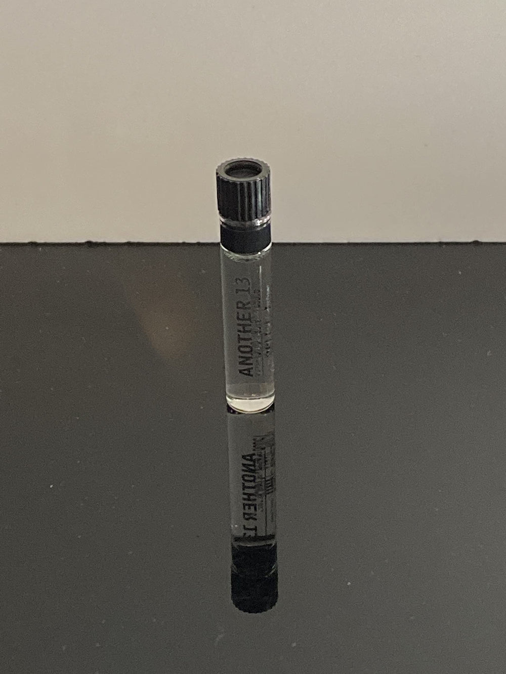 Label detail of Le Labo Another 13 dabber highlighting branding.