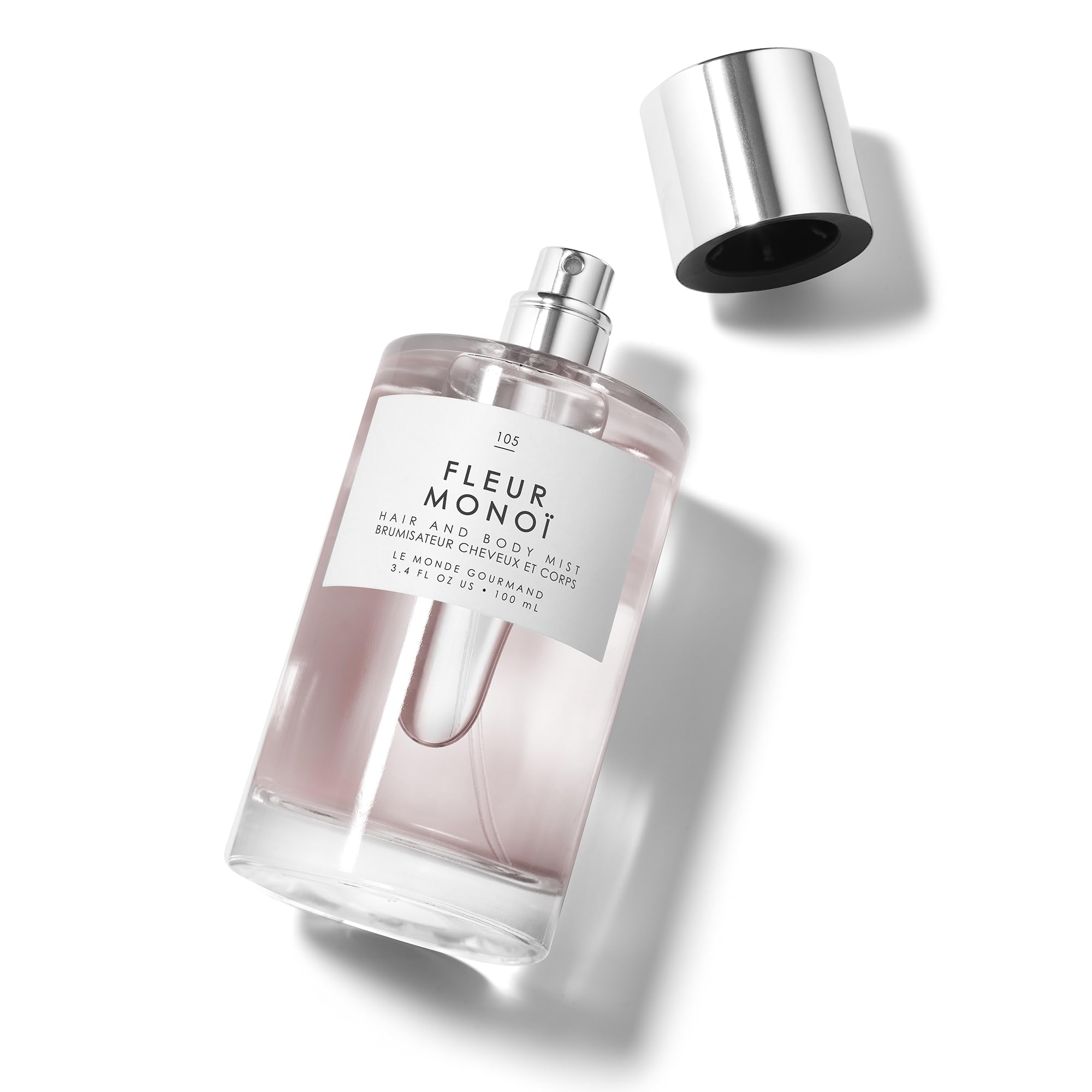 Le Monde Gourmand Fleur Monoi bottle closeup with flowers showing Gardenia and Neroli notes
