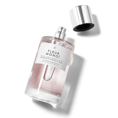 Le Monde Gourmand Fleur Monoi bottle closeup with flowers showing Gardenia and Neroli notes