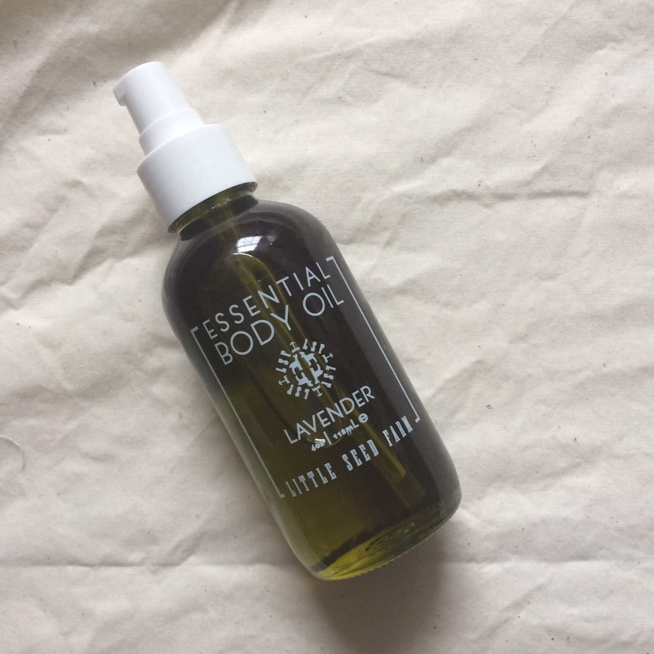 Drop of Little Seed Farm body oil on skin illustrating quick absorption.