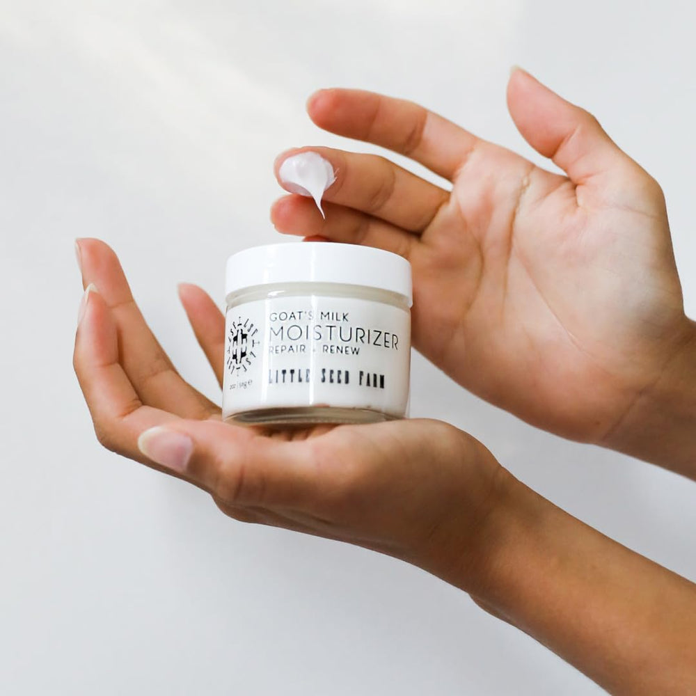 Glass bottle of Little Seed Farm Goat's Milk Face Moisturizer highlights eco-friendly packaging.