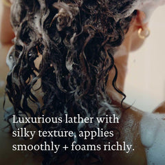 Hands applying products for detangled, hydrated hair routine