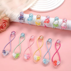 LIYAZHIL 12pcs ball charm hair ties wrapped around a ponytail for secure, decorative style.