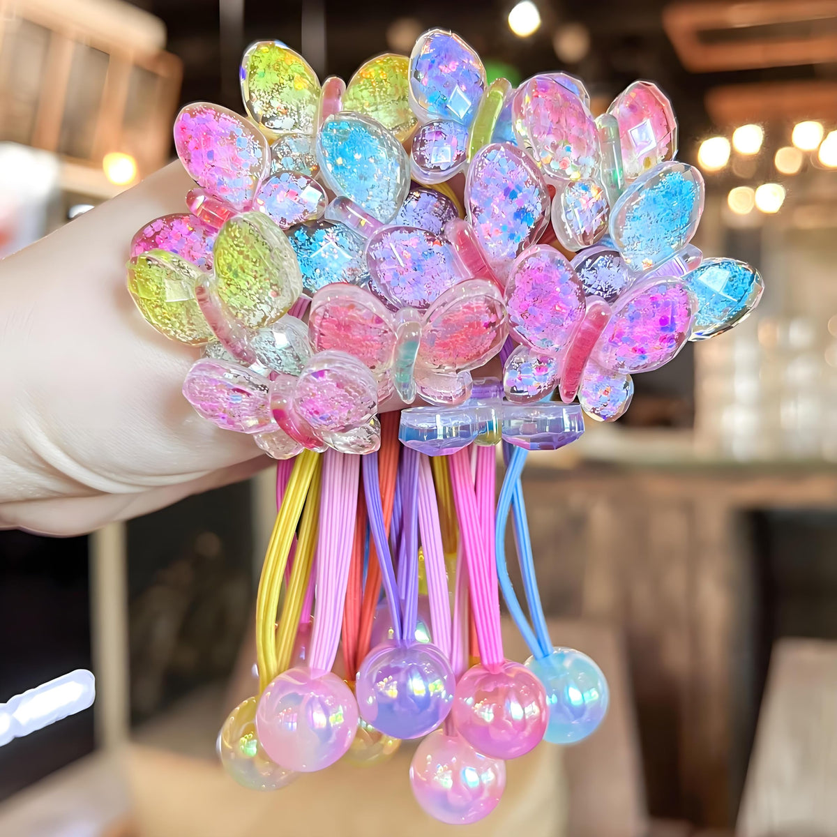 LIYAZHIL pink ball charm hair tie for gentle ponytail styling.