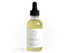 Lizush Lavender Body Oil bottle on a bathroom shelf for daily hydration.