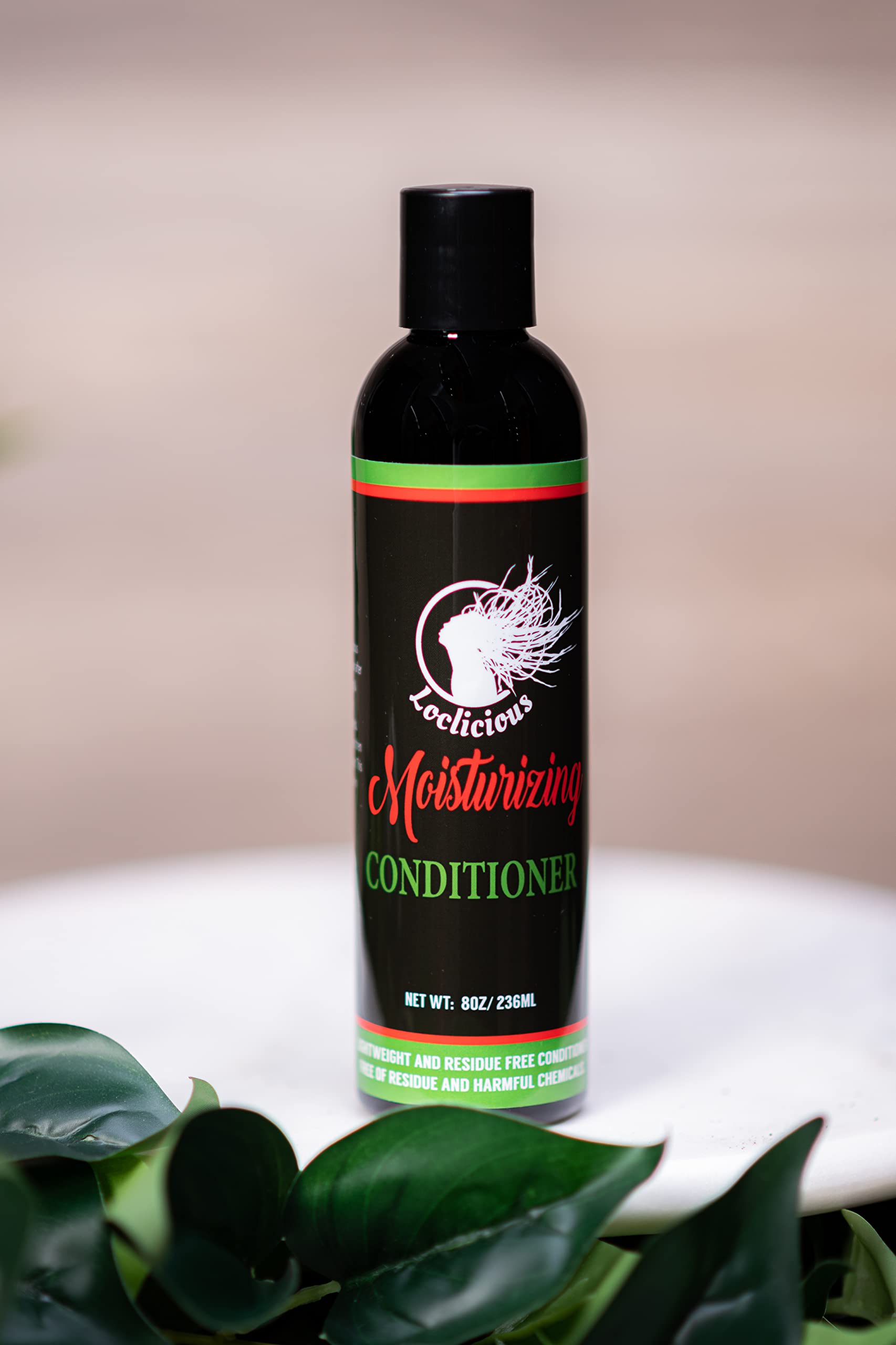 Loclicious Moisturizing Conditioner being applied to locs for moisture and manageability.
