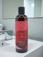 Long & Luxe ingredients close-up showcases pomegranate and passion fruit benefits.