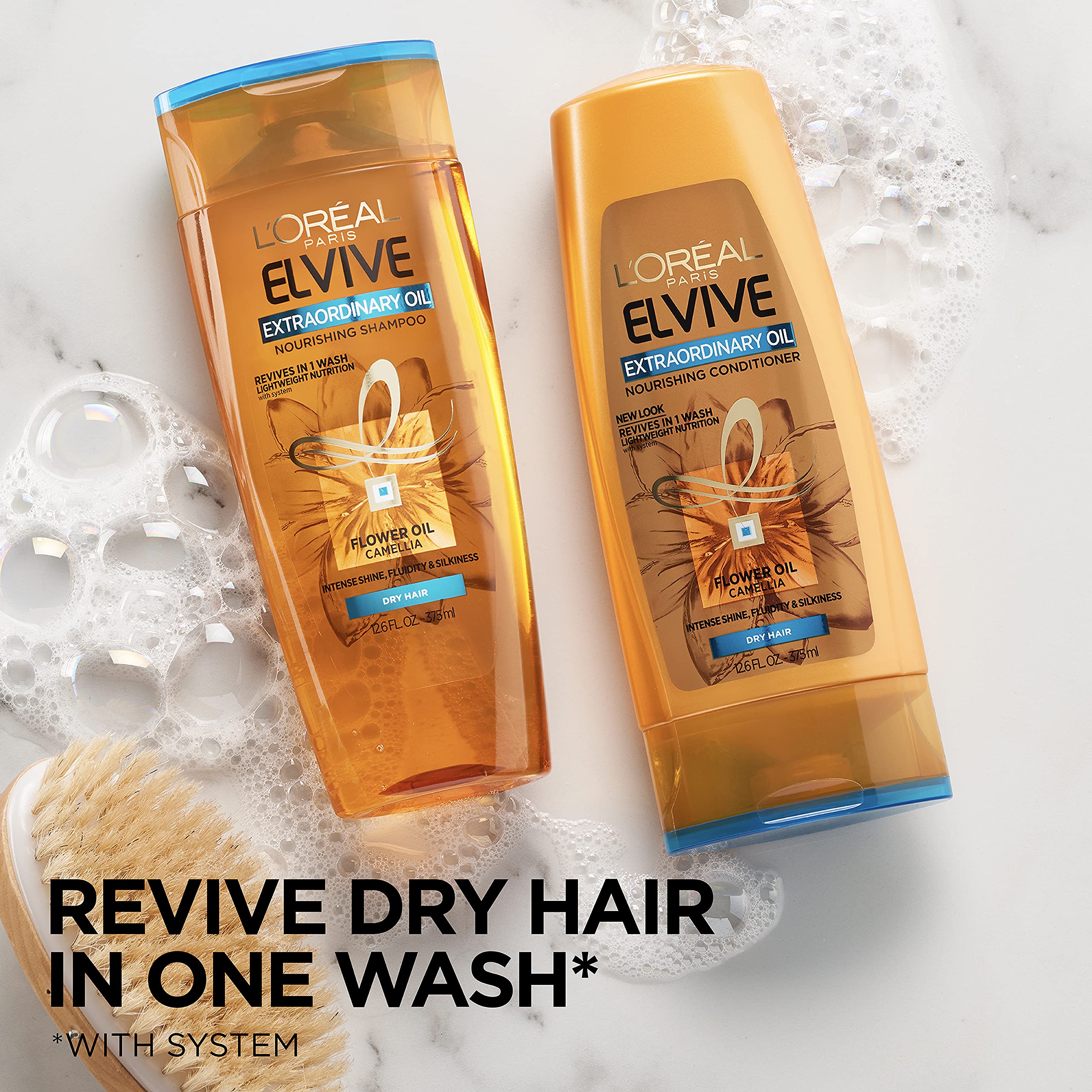 L'Oreal Paris Elvive Extraordinary Oil Shampoo is being lathered on wet hair.