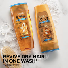 L'Oreal Paris Elvive Extraordinary Oil Shampoo is being lathered on wet hair.