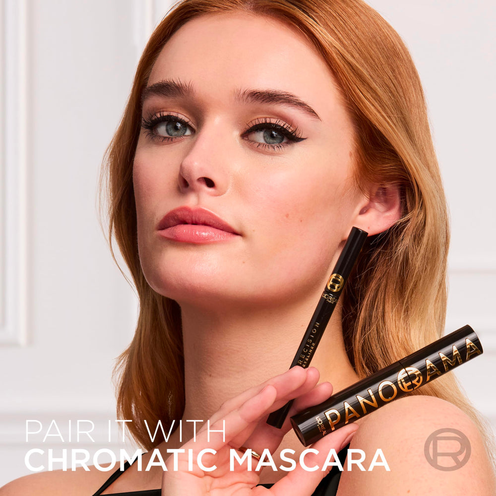 Applying Haute Precision eyeliner to the upper lash line for defined look.