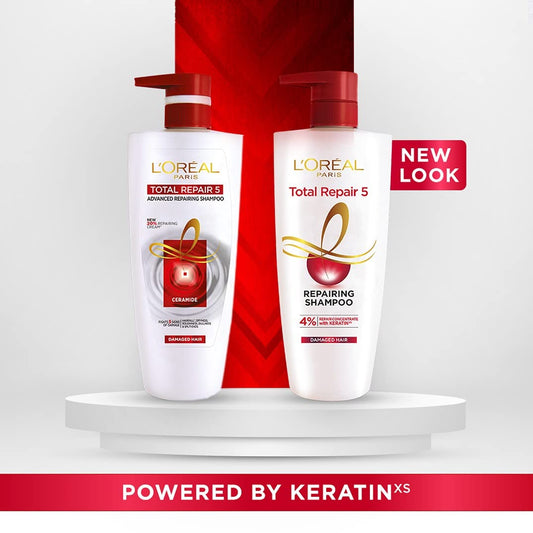 L'Oreal Paris Total Repair 5 Shampoo bottle close-up with visible lather signaling cleansing action.