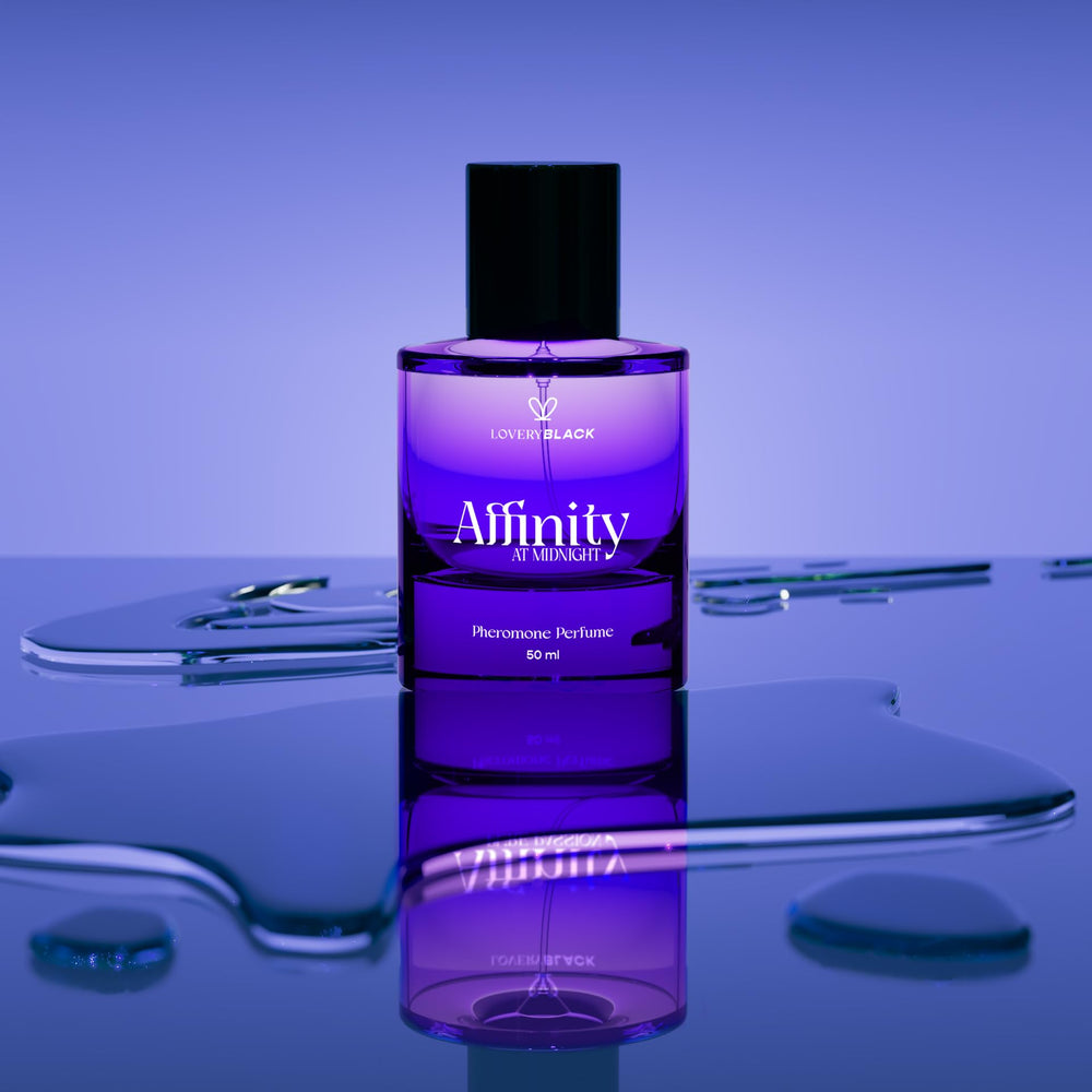LOVERY Affinity at Midnight wearer applying perfume on neck, creating a warm inviting aura.
