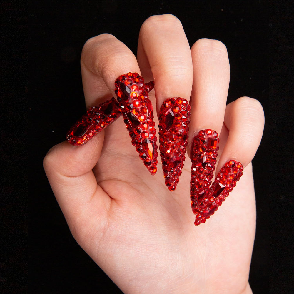 LOVFUL full-covered crystals nails catch light for a statement manicure.